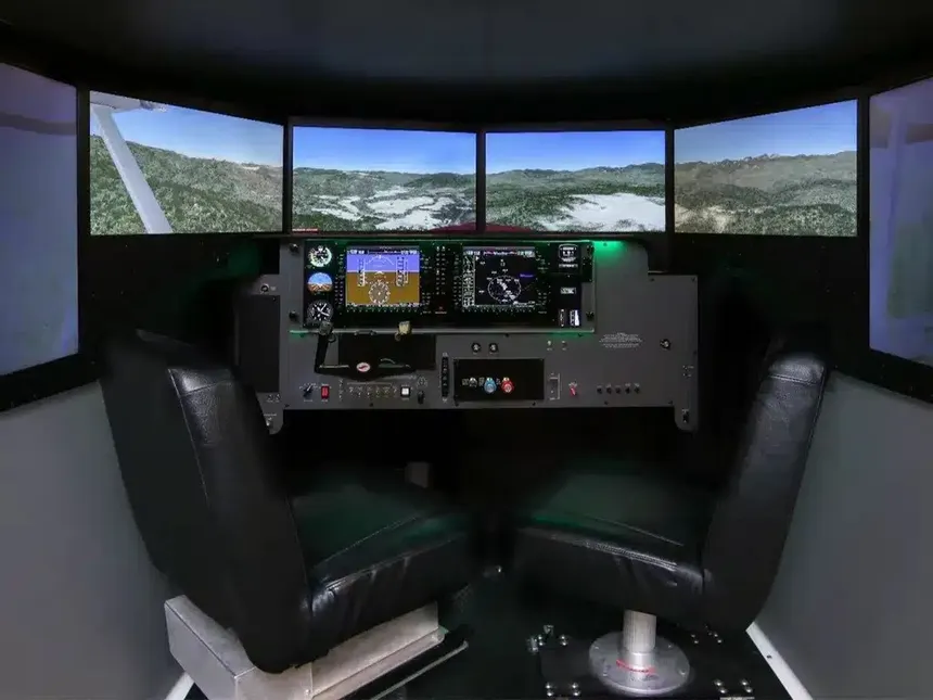 Instructor and student at the panel of the Apex Aviation Redbird FMX simulator
